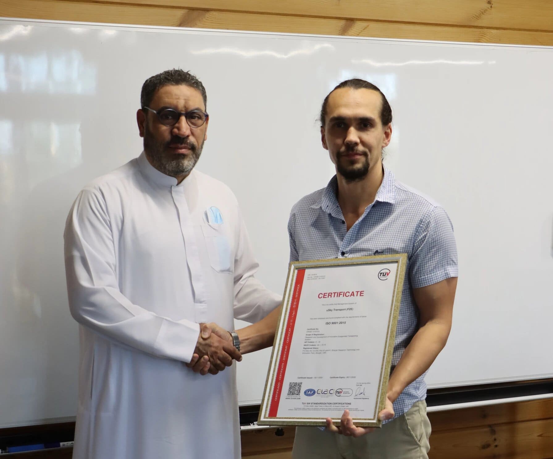 Mr. Mohanad Al Hamouta, TÜV SW, handing over ISO 9001 2015 quality certificate to Sergei Tarasov, uSky Transport